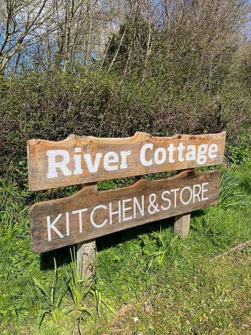 Wooden sign for River Cottage Kitchen & Store.